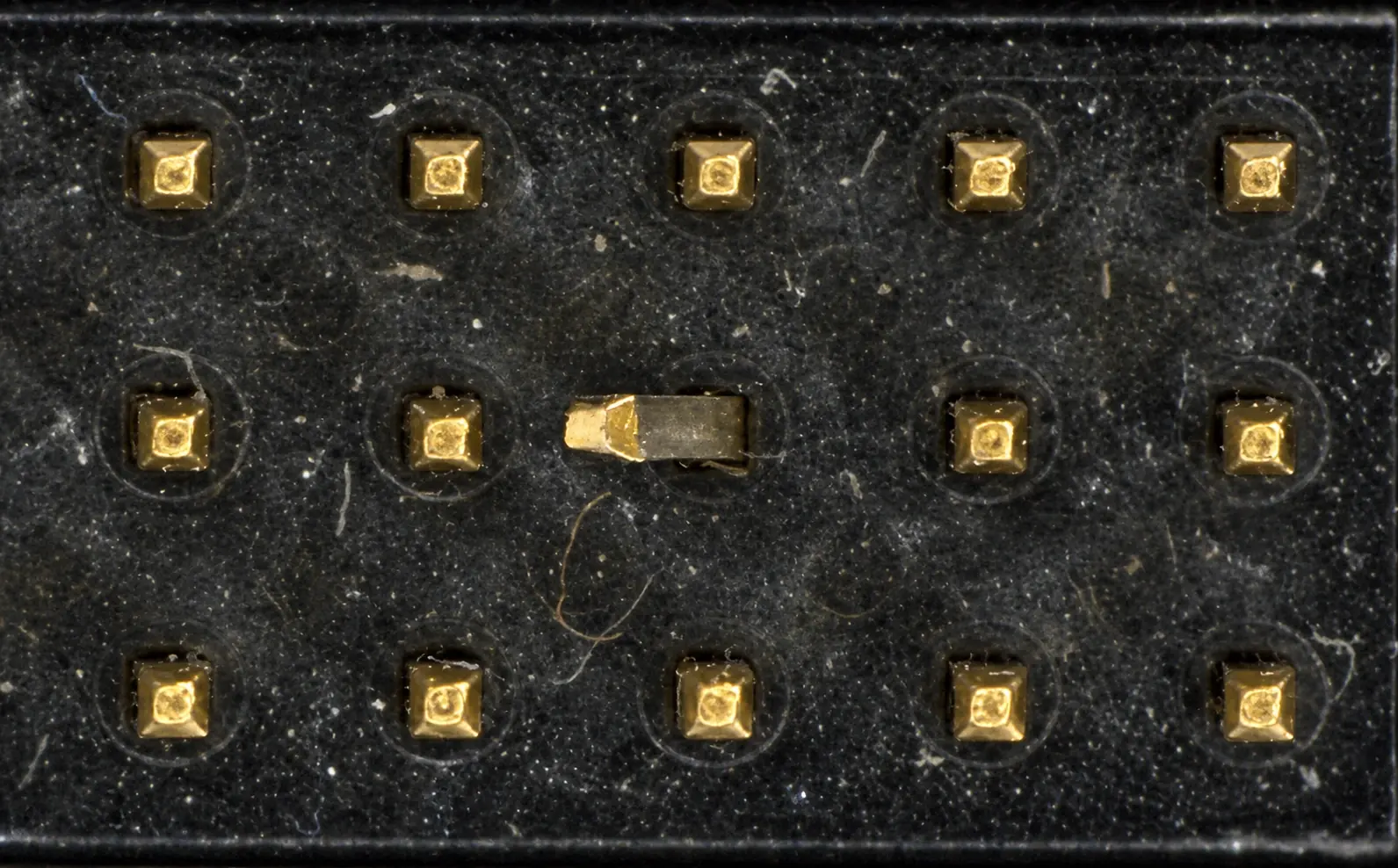 Restored connector inspection capture showing a physically bent center contact among fifteen gold pins