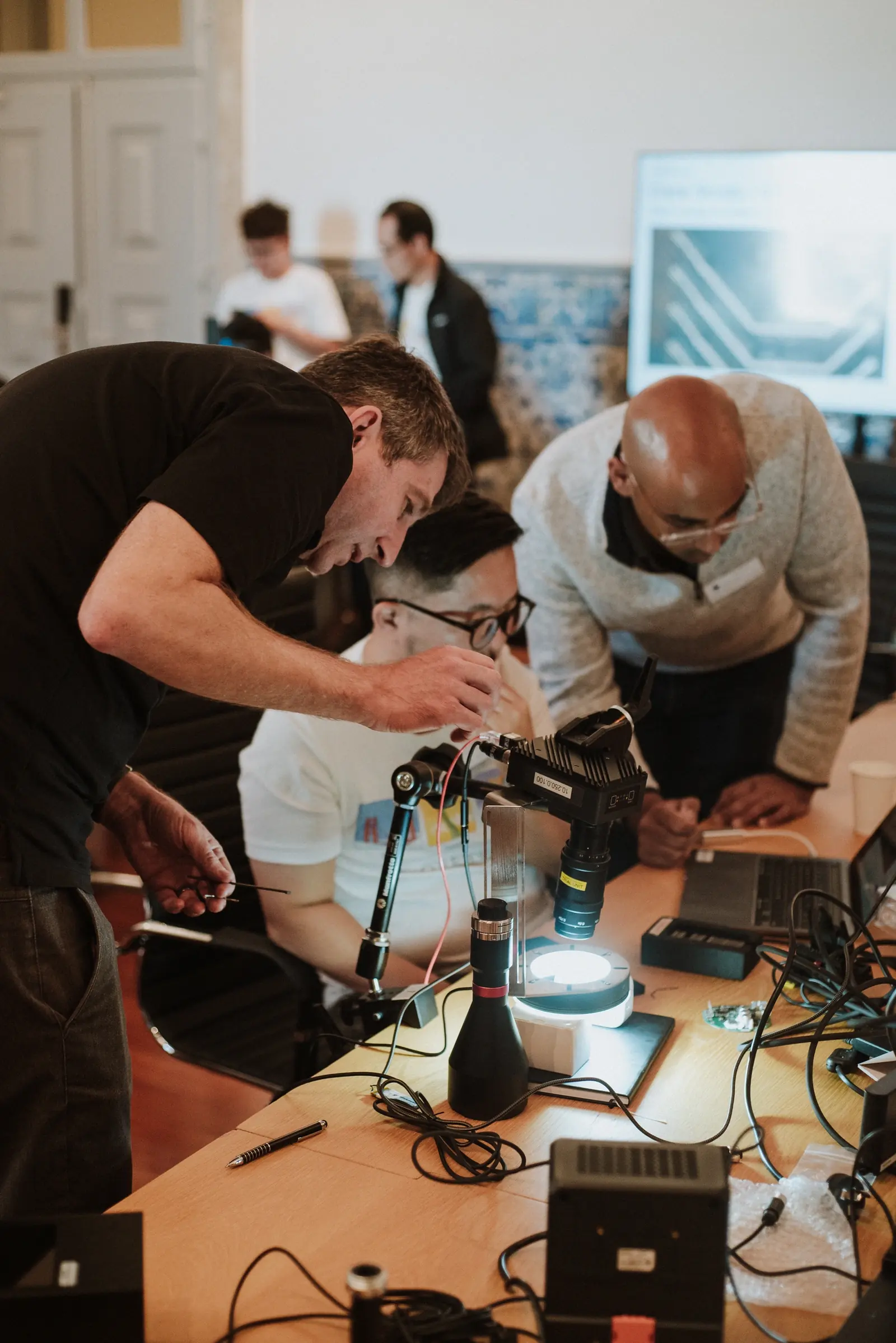 Workshop participants working together to adjust an Overview camera and inspection lighting