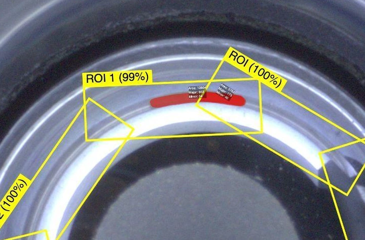 borescope capture with a red segmentation mask locating debris inside the groove